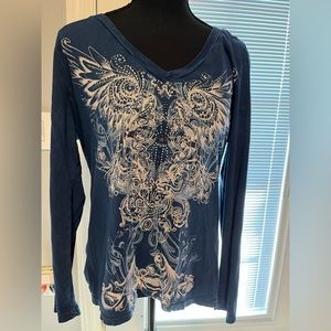 Woman’s blouse with a beautiful design on the front with sparkles.